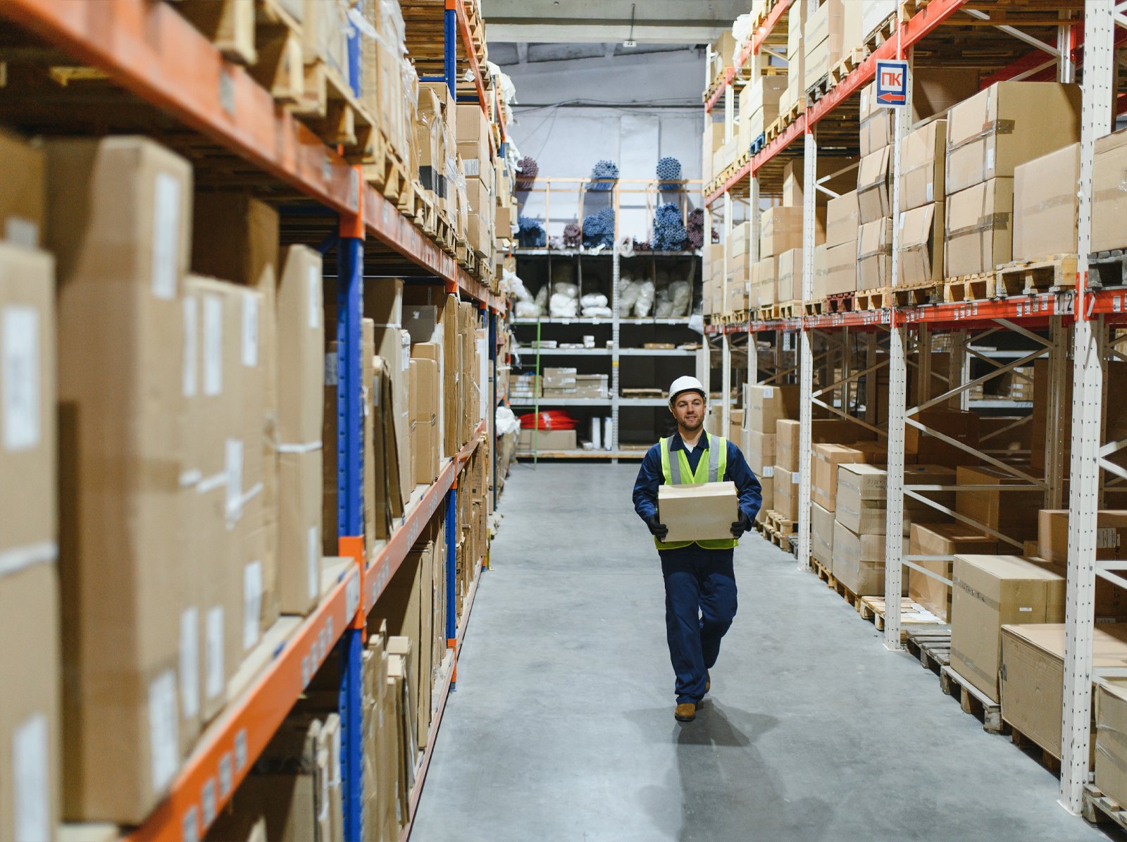 Fulfilment centre aisle lined with shelves of boxed stock